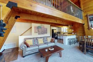 a living room with a couch and a table at Whistle Stop Cabin in Lake Arrowhead
