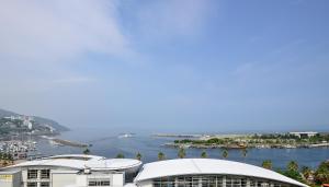 a view of a body of water with buildings at Hotel Sunmi Club in Atami