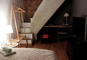 a bedroom with a bed and a desk and a staircase at Casa Cecilia Apartment Algarve in Alte