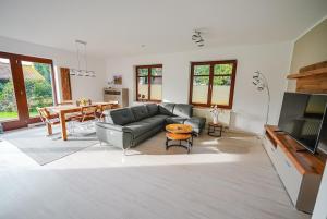 a living room with a couch and a table at Ferienwohnung Am Waldteich in Schwerin