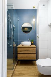 a bathroom with a sink and a shower at Kairos Apartments - Royal Premium - parking podziemnym gratis, ścisłe centrum in Gliwice