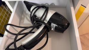 a black and white hair dryer in a drawer at En vacances, comme à la maison in La Joue du Loup +27 photos