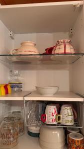 a refrigerator filled with lots of dishes and bowls at En vacances, comme à la maison in La Joue du Loup