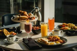 a table topped with plates of food and drinks at Marriott Montreal Airport In-Terminal Hotel in Dorval
