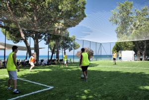 a group of people playing soccer on a soccer field at Ephesia Holiday Beach Club in Kuşadası
