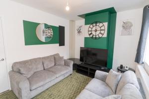a living room with a couch and a flat screen tv at Perfect for Contractors & Families - Free Parking in Banbury
