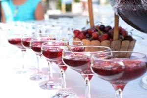 a row of wine glasses filled with red wine at Ephesia Holiday Beach Club in Kuşadası
