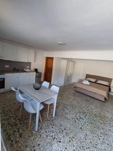 a room with a table and chairs and a bed at The Forest Villa in Zacharo
