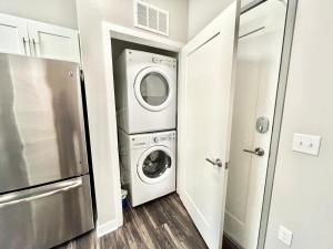 a laundry room with a washer and dryer at Urban Oasis Downtown Condo with Skywalk Access 3 in Des Moines