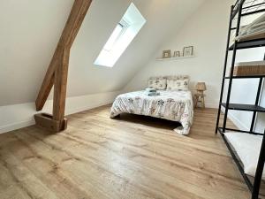 a bedroom with a bed and a ladder at Appartement Vanille in Pontivy +2 photos