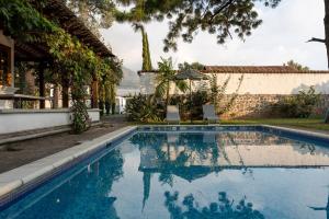 a swimming pool in front of a house at Chalet Irene in Panajachel