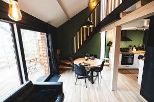 a dining room and kitchen with a table and chairs at Cosy Wood in Hastière-par-delà