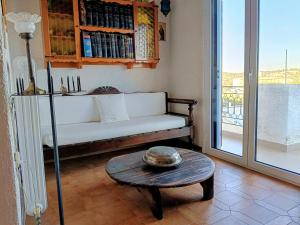 a living room with a couch and a table at Holiday House in Porto Heli