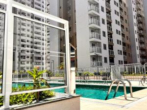 uitzicht op een zwembad vanuit een gebouw bij Apartamento de 2 quartos, com piscina e há 10 km de copacabana in Rio de Janeiro