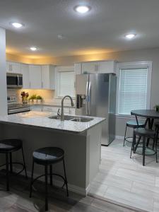 a kitchen with a sink and a refrigerator at Luxurious and peaceful in Topeka
