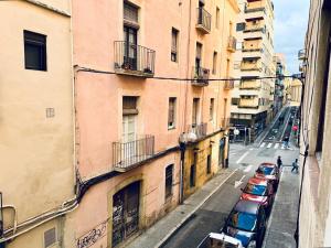 a row of cars parked on a street next to buildings at Dream Apartment Céntrico in Tarragona