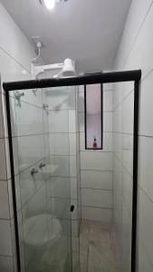 a bathroom with a shower with a glass door at Loft Alto Padrão Um Quarto in Recife