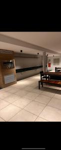 a empty room with a bench in a building at Loft Alto Padrão Um Quarto in Recife