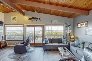 a living room with a couch and a table at Pacific Hideaway in Rockaway Beach
