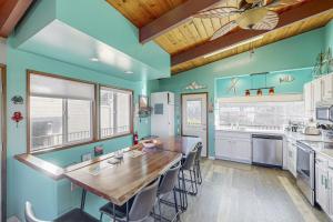 a kitchen with blue walls and a wooden table at Pacific Hideaway in Rockaway Beach