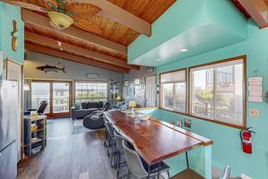 a kitchen with a large wooden table in a room at Pacific Hideaway in Rockaway Beach +32 photos
