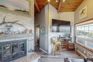 a living room with a fireplace and a couch at Pacific Hideaway in Rockaway Beach