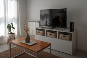 a living room with a tv and a coffee table at Departamento Rivadavia Centro in Santa Rosa