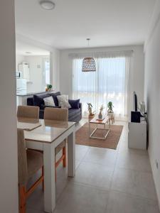 ein Wohnzimmer mit Sofa und Tisch in der Unterkunft Departamento Rivadavia Centro in Santa Rosa