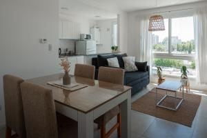 a kitchen and living room with a table and a couch at Departamento Rivadavia Centro in Santa Rosa