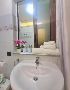 a bathroom with a white sink and a mirror at Ma Maison Etnea in Catania +21 photos