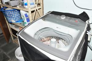 a washing machine with its door open in a room at Casa com Quarto Duplo com Banheiro Privativo in Rio de Janeiro