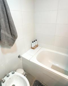 ein weißes Badezimmer mit Badewanne und Toilette in der Unterkunft Departamento Rivadavia Centro in Santa Rosa