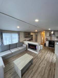 a living room with a couch and a table at 34 Brean Leisure Park Unity Beach 6 berth Passes optional No pets in Brean
