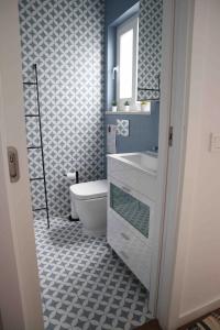 a bathroom with a toilet and a sink and a mirror at Casa da Mostardeira in Évora +33 photos