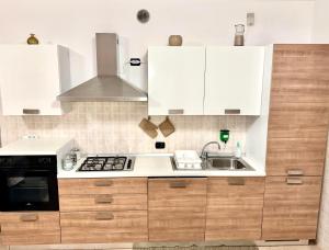 a kitchen with white cabinets and a sink at Top Apartment 2 in Castel d'Azzano +26 photos