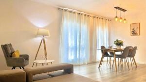 a living room with a table and a dining room at Apartamento Verde Atlântico in Ponta Delgada