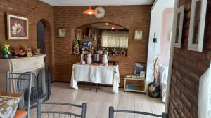 a dining room with a table and a brick wall at Tierra del Sol in Merlo