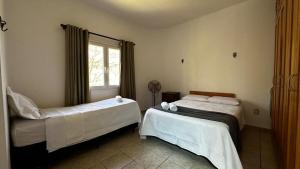 Ένα ή περισσότερα κρεβάτια σε δωμάτιο στο Casa Maria Fulô