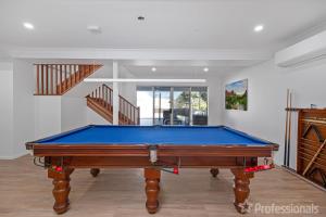 a pool table in the middle of a room at Zilzie Beach House in Zilzie