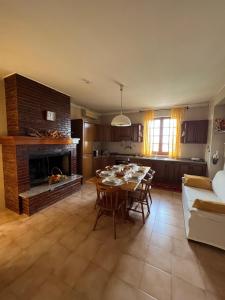 a living room with a table and a fireplace at Casa MaRo' in Capaci