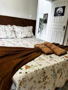a bed with a blanket on top of it at Centro Histórico Diamantina in Diamantina +17 photos