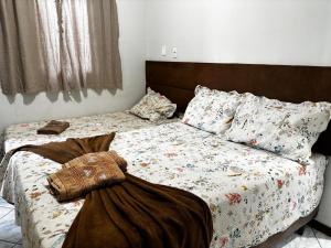 a bed with a blanket and pillows on it at Centro Histórico Diamantina in Diamantina