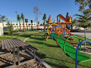 a park with a playground with a colorful slide at Casa Alba completa en Residencial Facturamos in Santa Gertrudis