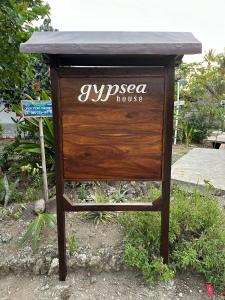 a sign that saysushoco house on top of a table at gypsea house in Batukaras +5 photos