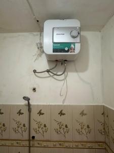 a small box on the wall of a bathroom at gypsea house in Batukaras