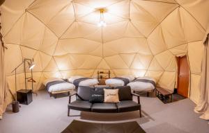 a room with four beds and a couch in a igloo at Relam Glamping Resort Gotemba in Gotemba