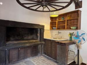 a kitchen with a wooden counter and a fan at La Casa de Ignacia in Estación Ramallo