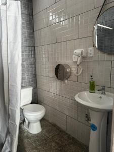a bathroom with a toilet and a sink at Casa Zakura in Guatemala +12 photos