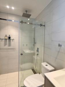 a bathroom with a shower and a toilet and a sink at New Mini Suite, La Carolina in Quito