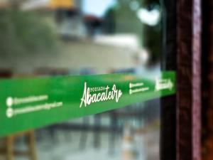a green sign with the name of a restaurant at Pousada Abacateiro in Búzios